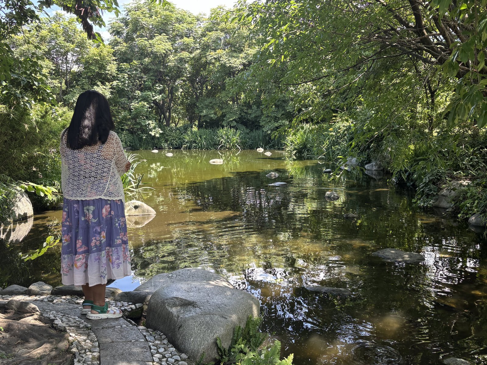 Mital by the long pond, reflected pagoda behind her